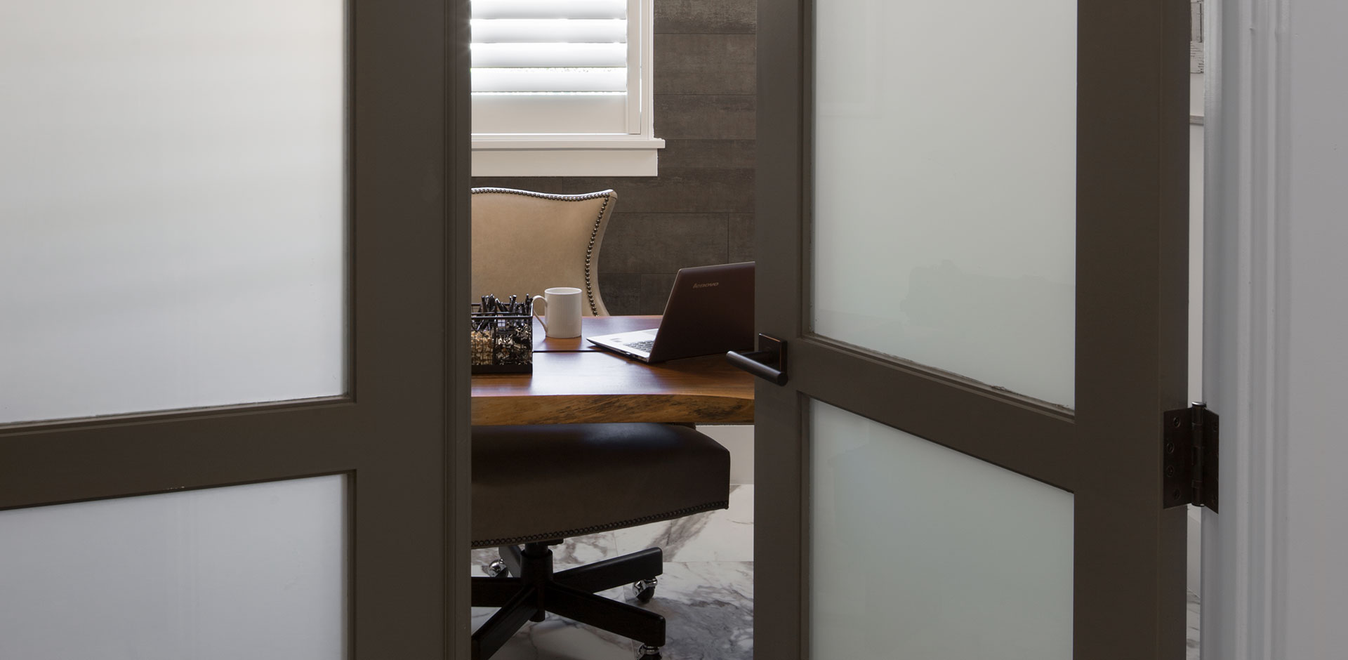 Looking into an office through a pair of TS3000 doors in MDF with white lami glass