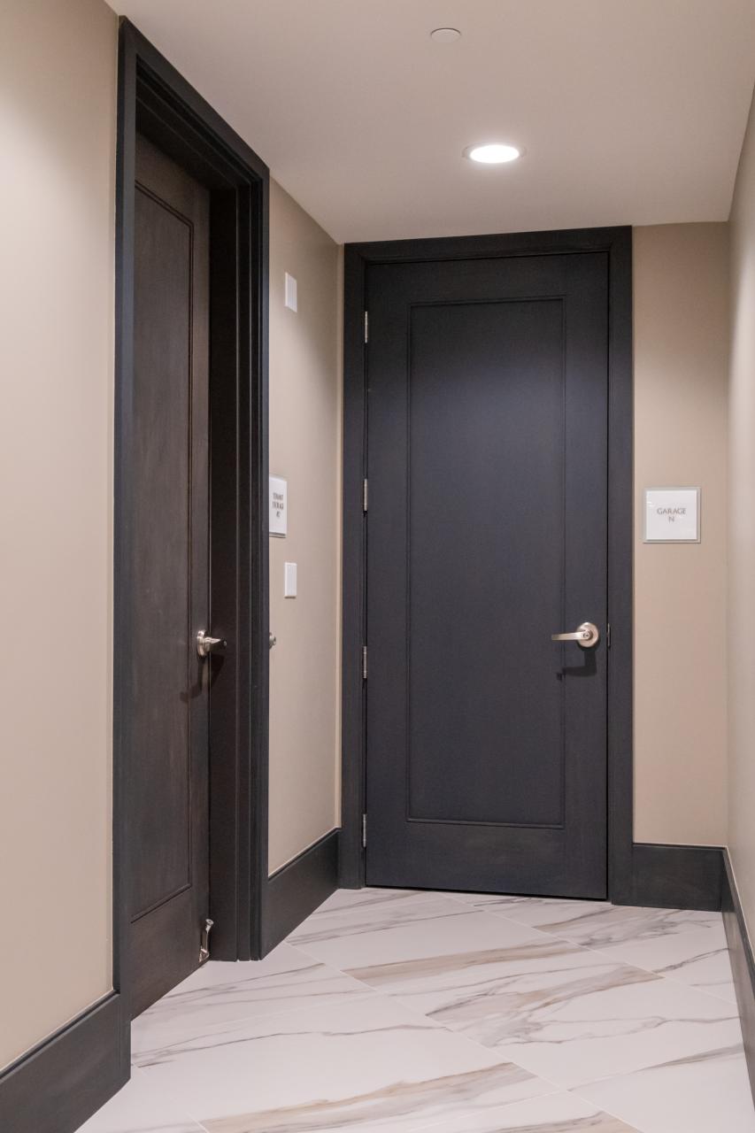 Condominium tower featuring TS1000 doors, in rift sawn white oak with Quirk (QM) moulding and Flat (C) panel in lobby.