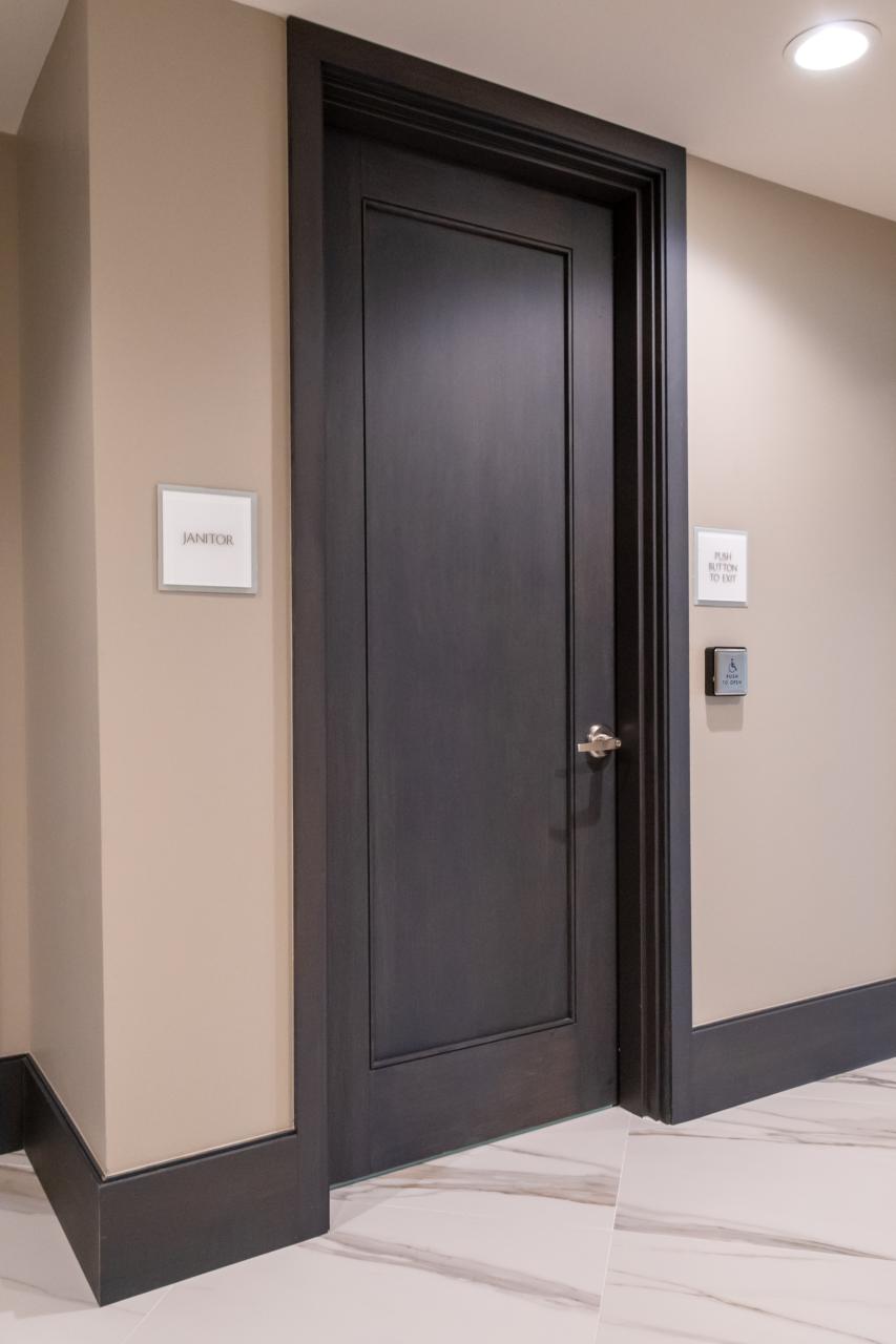 Condominium tower featuring TS1000 doors, in rift sawn white oak with Quirk (QM) moulding and Flat (C) panel in lobby.